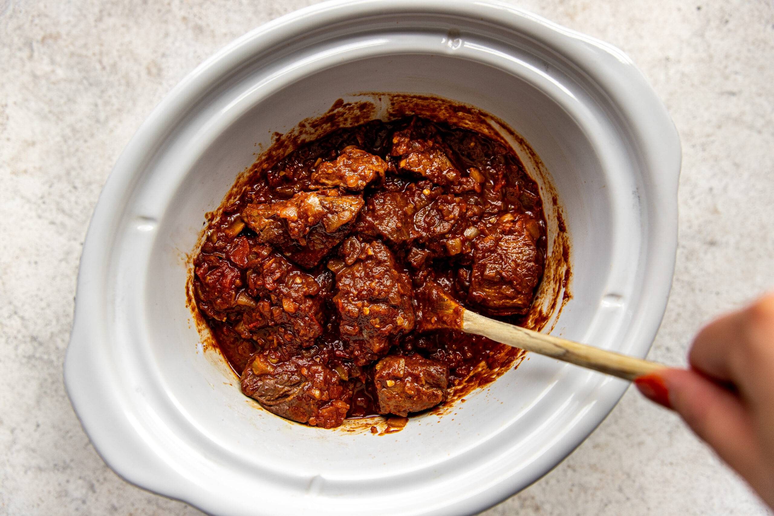 Texas chili in a slow cooker before cooking.