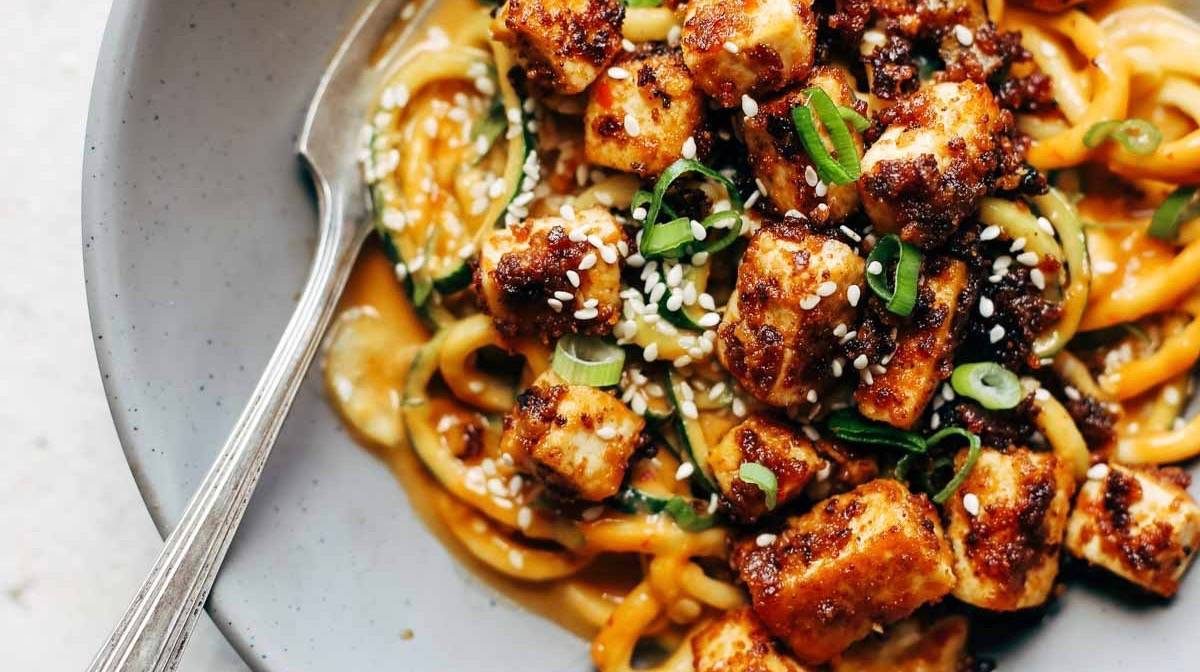Sesame Zoodles wiht Tofu in a bowl.