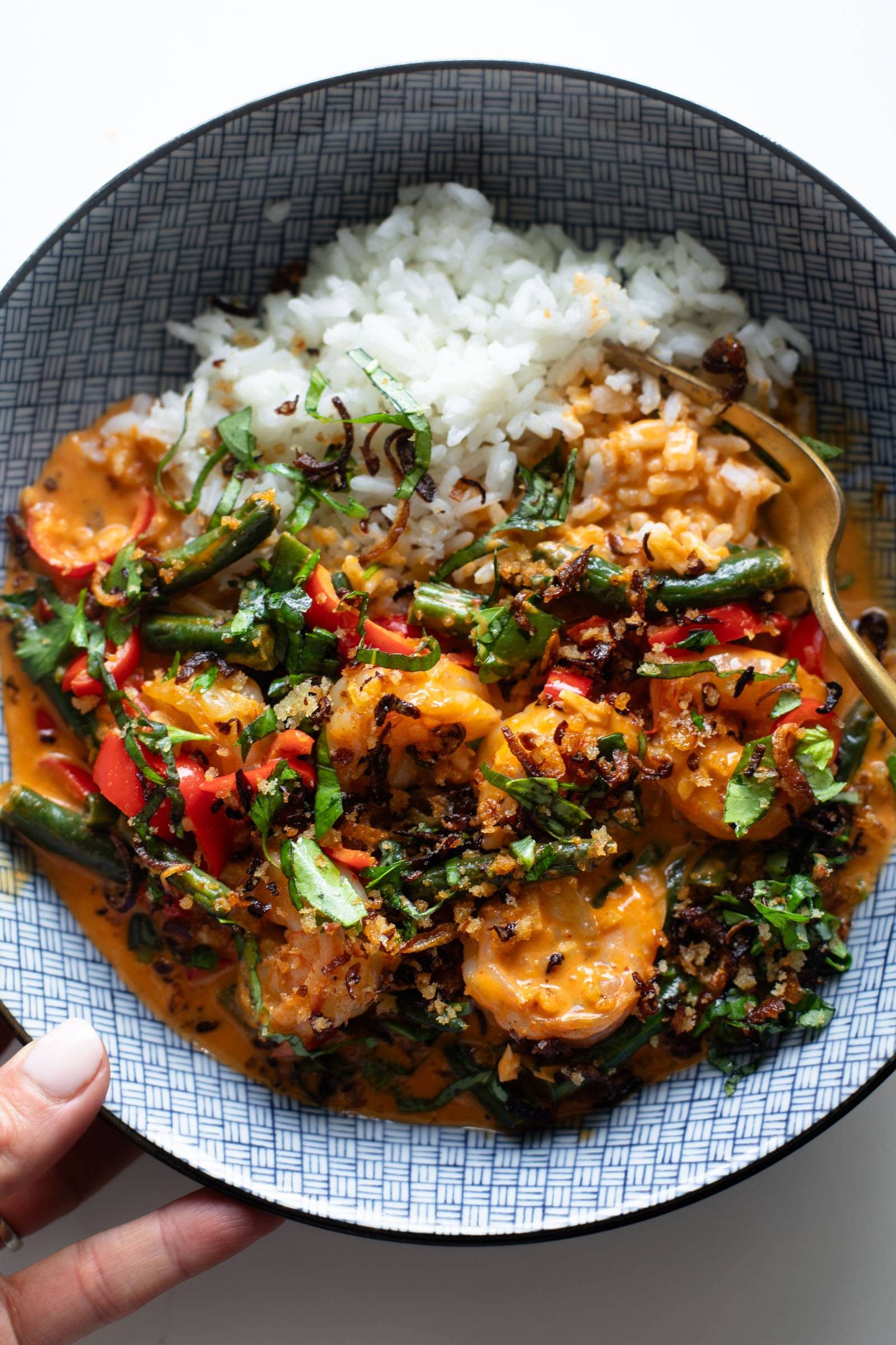 Shrimp curry in a bowl with rice.